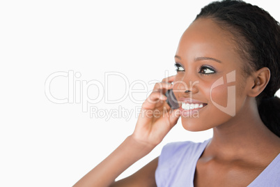 Close up of woman talking on her phone on white background