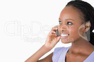 Close up of woman talking on her phone on white background