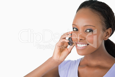 Close up of woman on the phone against a white background