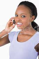 Close up of woman talking on the phone against a white backgroun