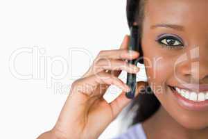 Close up of woman on her phone against a white background