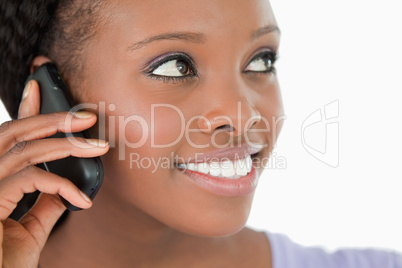 Close up of woman listening to caller on white background