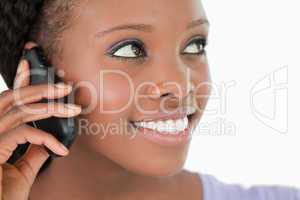 Close up of woman listening to caller on white background