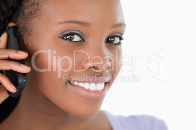Close up of woman listening closely to caller on white backgroun