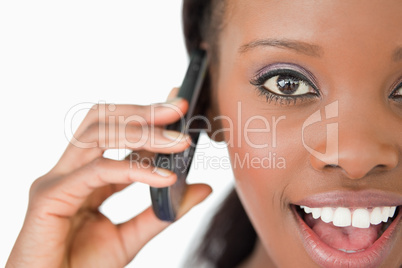 Close up of surprised woman on the phone on white background