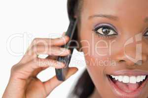 Close up of surprised woman on the phone on white background
