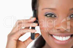Close up of woman using mobile phone on white background