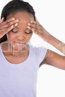 Close up of woman experiencing a headache on white background