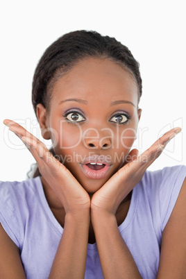 Close up of frightened woman against a white background