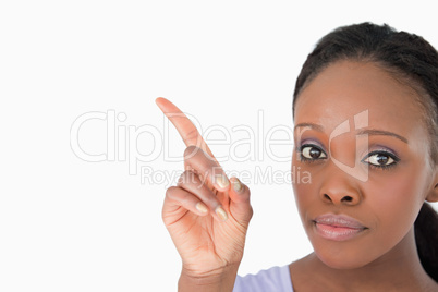 Close up of woman showing something next to her on white backgro