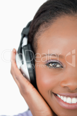 Close up of young woman with headphones on white background