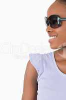 Close up of smiling woman with sunglasses on white background