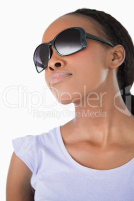 Close up of woman wearing her sunglasses against a white backgro