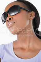 Close up of woman wearing her sunglasses on white background