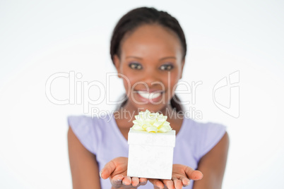 Close up of present being held by woman against a white backgrou