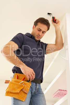 Electrician Installing Light Fitting In Home
