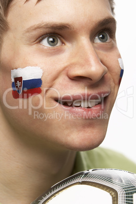 Young Male Football Fan With Slovakian Flag Painted On Face
