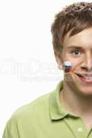 Young Male Sports Fan With Slovakian Flag Painted On Face