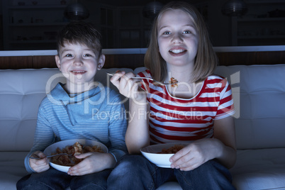 Children Enjoying Meal Whilst Watching TV