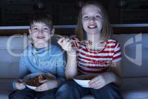 Children Enjoying Meal Whilst Watching TV
