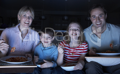 Family Enjoying Meal Whilst Watching TV