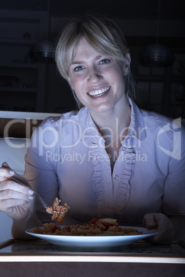 Woman Enjoying Meal Whilst Watching TV