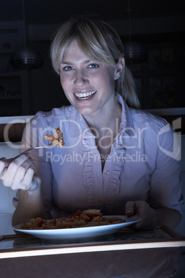 Woman Enjoying Meal Whilst Watching TV