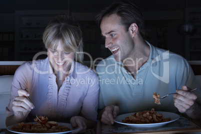 Couple Enjoying Meal Whilst Watching TV