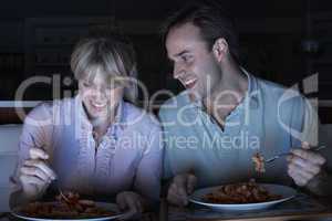 Couple Enjoying Meal Whilst Watching TV