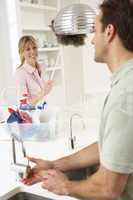 Couple Doing Housework In Kitchen Together