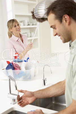 Couple Doing Housework In Kitchen Together