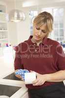 Cleaner Working In Domestic Kitchen