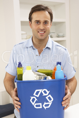 Man Holding Recyling Waste Bin At Home
