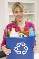 Woman Holding Recyling Waste Bin At Home