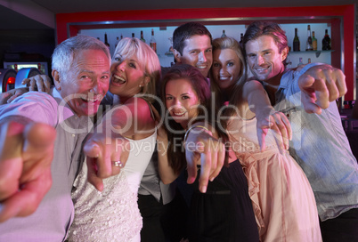 Group Of People Having Fun In Busy Bar