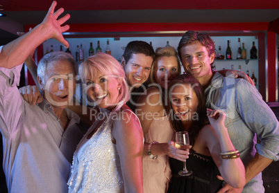 Group Of People Having Fun In Busy Bar