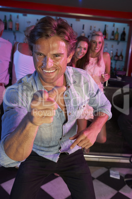 Young Man Having Fun In Busy Bar