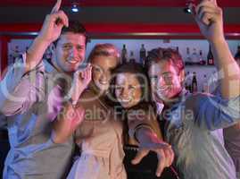 Group Of Young People Having Fun In Busy Bar