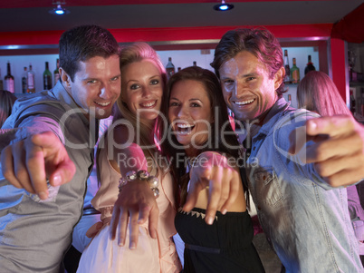 Group Of Young People Having Fun In Busy Bar