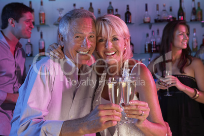 Senior Couple Having Fun In Busy Bar