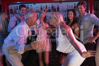 Senior Couple Having Fun In Busy Bar