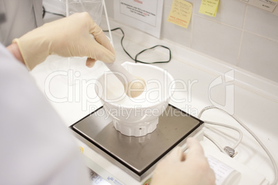 woman in a laboratory with electronic balance