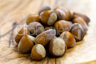 Composition from nuts on the wooden background