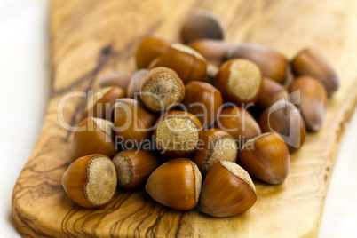 Composition from nuts on the wooden background