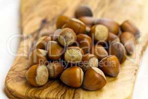 Composition from nuts on the wooden background