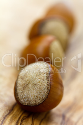 Composition from nuts on the wooden background