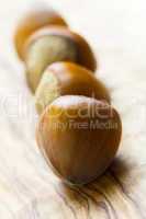 Composition from nuts on the wooden background