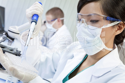 Chinese Female Woman Scientist Using Pipette In Laboratory