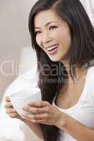 Beautiful Chinese Oriental Asian Woman Drinking Tea or Coffee