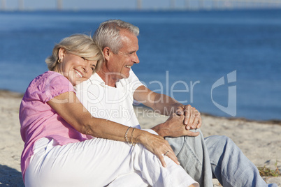 Happy Romantic Senior Couple Sitting Together on Beach